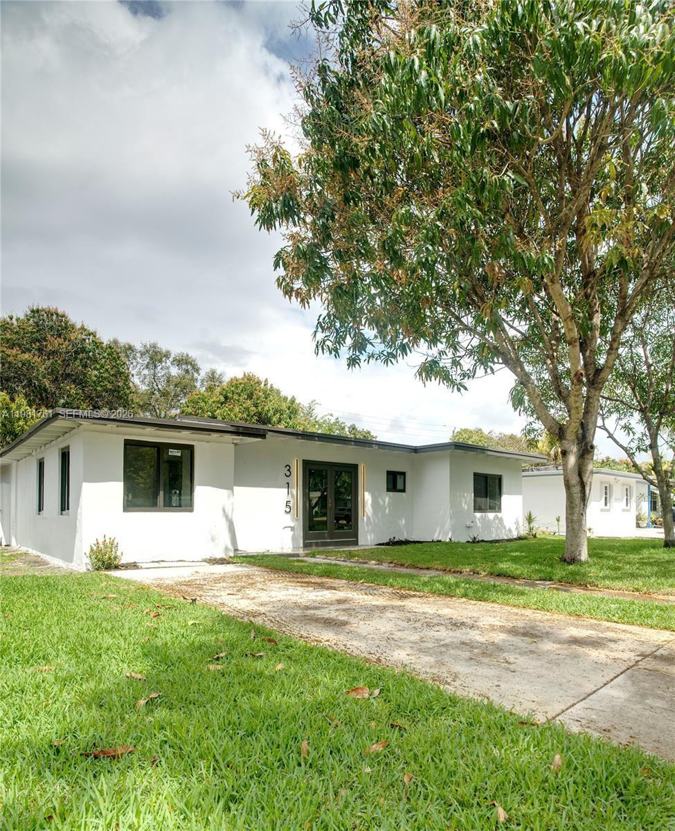 315 Northwest 127th Street North Miami, FL 33168 - Photo 61 of 67 a front view of house with yard and green space