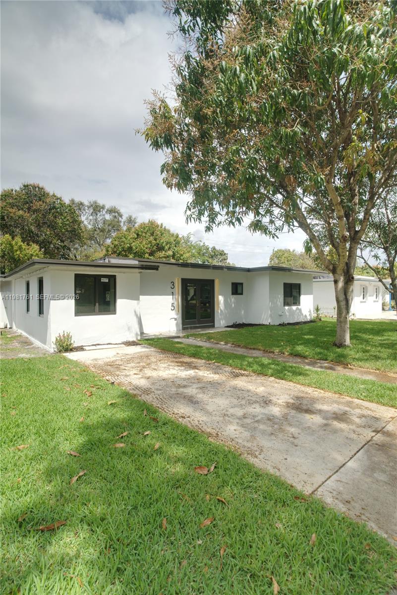 315 Northwest 127th Street North Miami, FL 33168 - Photo 62 of 67 a front view of a house with a garden and yard