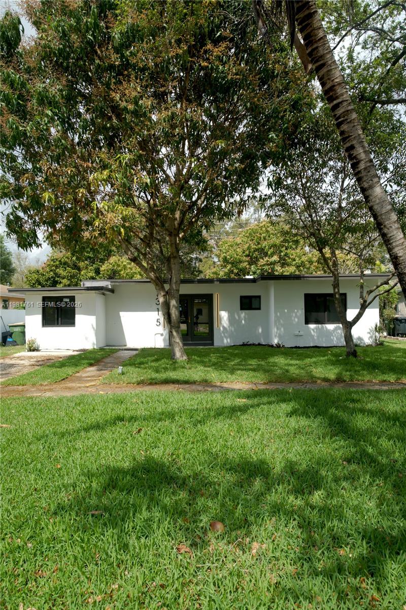 315 Northwest 127th Street North Miami, FL 33168 - Photo 63 of 67 a front view of a house with a garden