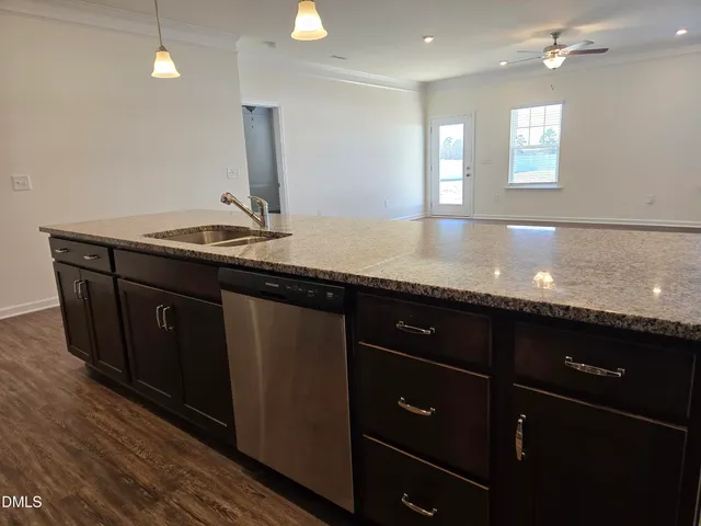 a bathroom with double vanity and a large mirror