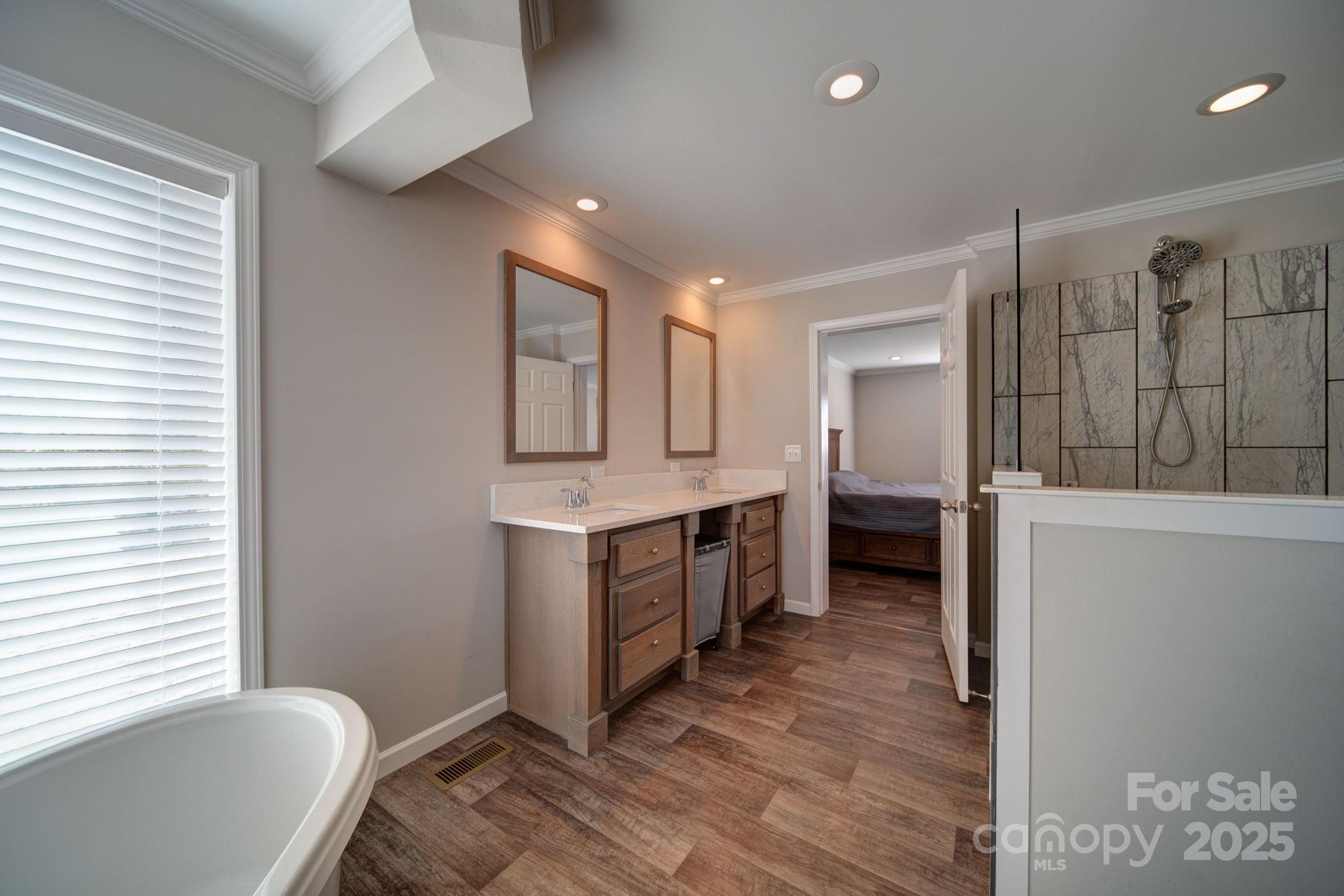 428 Long Branch Jefferson, SC 29718 - Photo 7 of 27 a large bathroom with a tub double vanity sink and a mirror