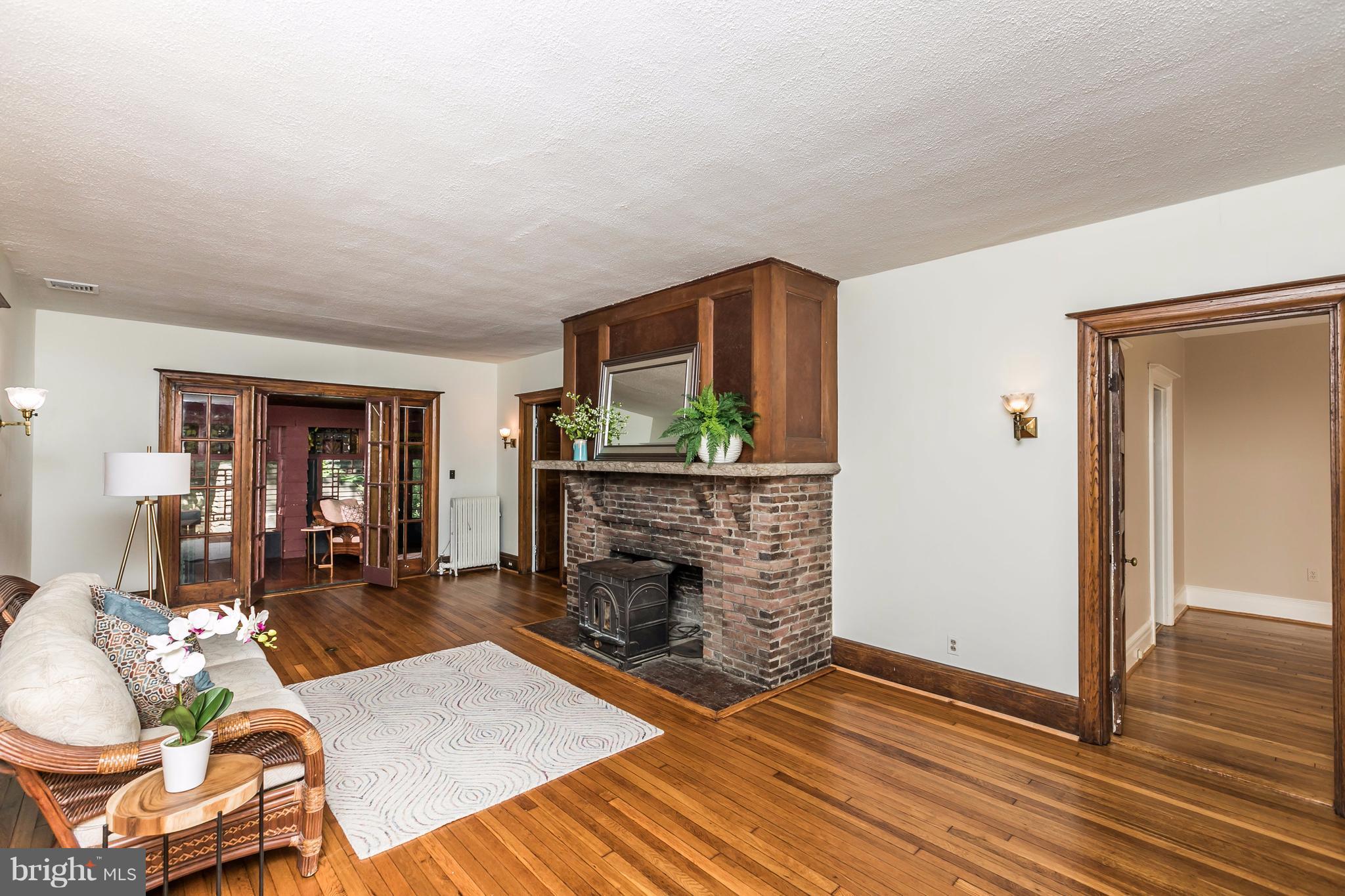 212 Longwood Road Baltimore, MD 21210 - Photo 2 of 30 a living room with furniture a fireplace and a flat screen tv