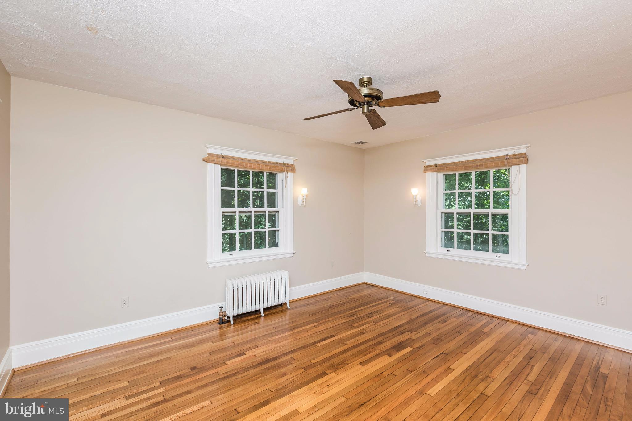 212 Longwood Road Baltimore, MD 21210 - Photo 12 of 30 a view of empty room with wooden floor and fan