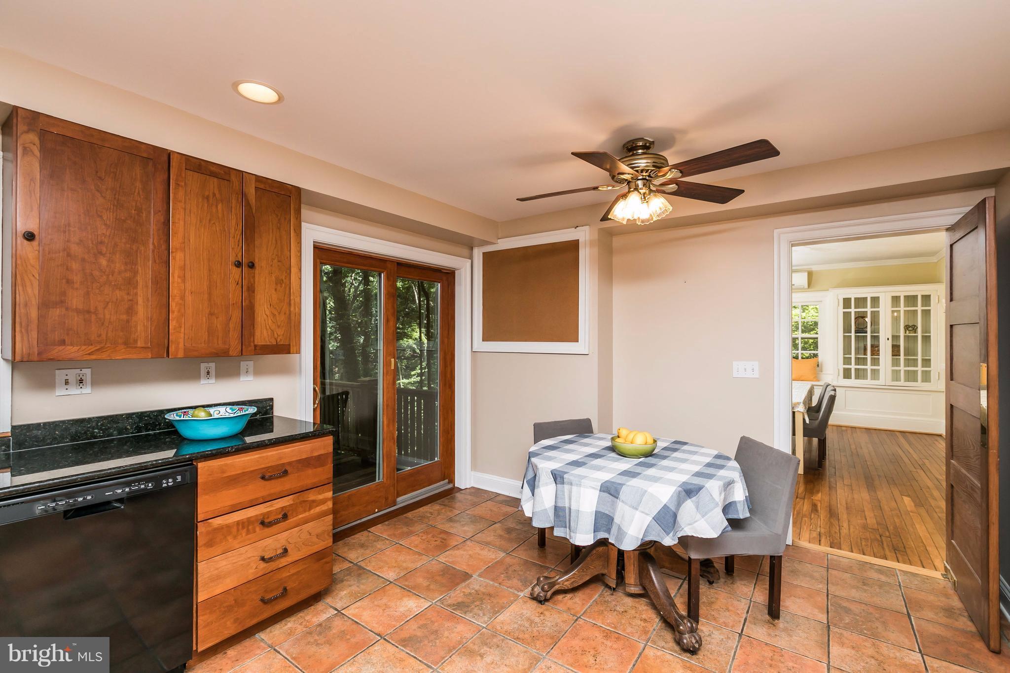 212 Longwood Road Baltimore, MD 21210 - Photo 17 of 30 a kitchen with a table chairs and a refrigerator