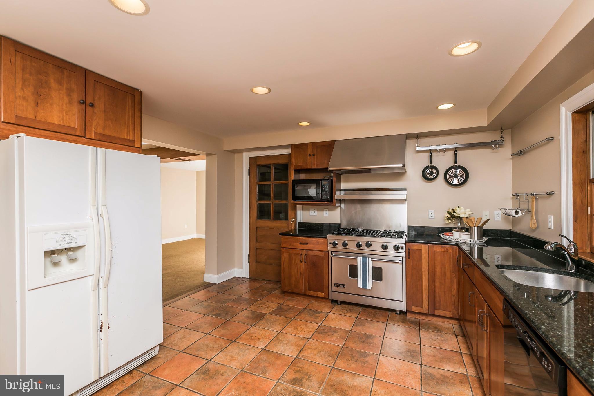 212 Longwood Road Baltimore, MD 21210 - Photo 19 of 30 a kitchen with stainless steel appliances granite countertop a stove and a refrigerator