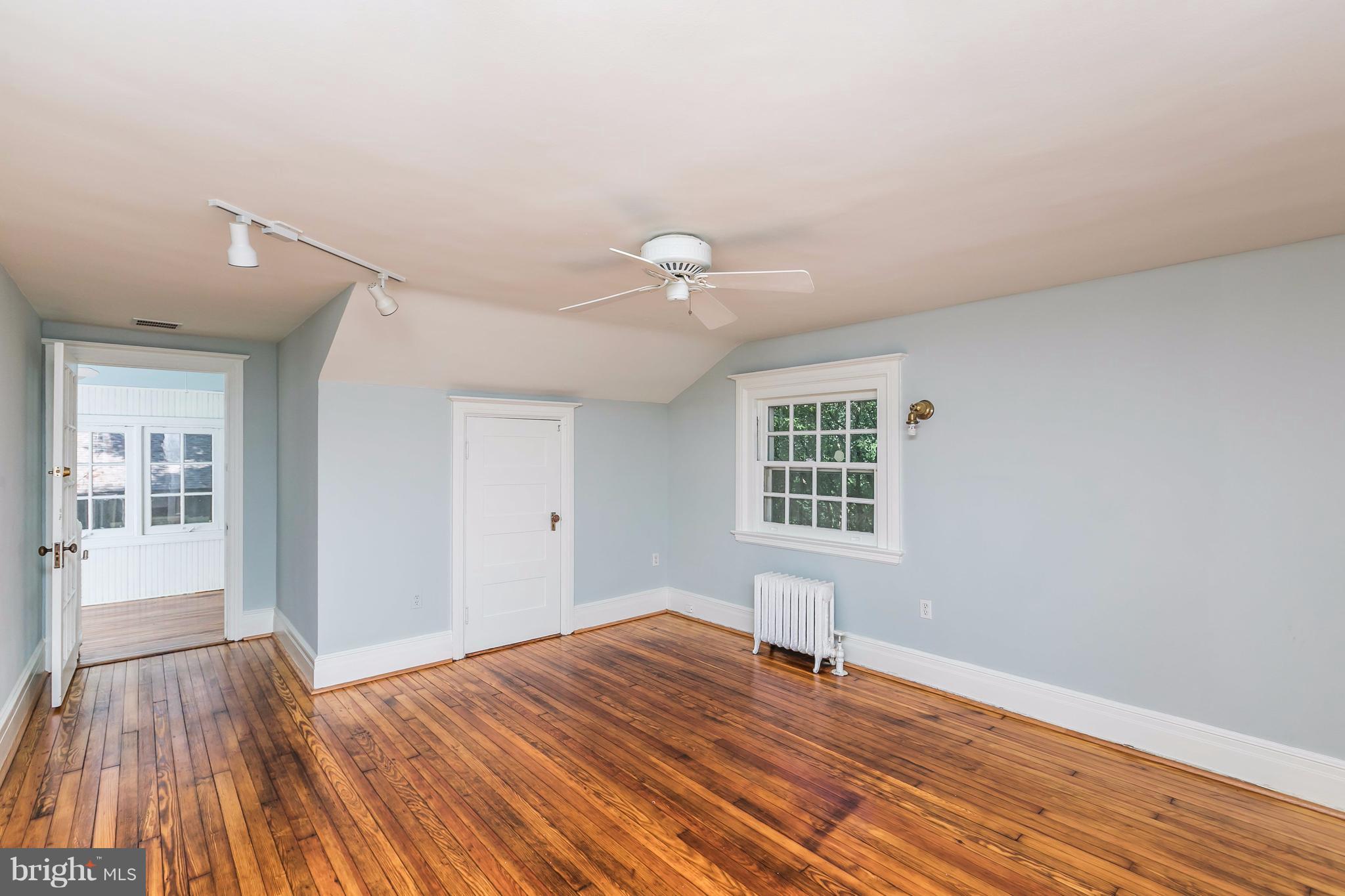 212 Longwood Road Baltimore, MD 21210 - Photo 26 of 30 a view of empty room with wooden floor and fan