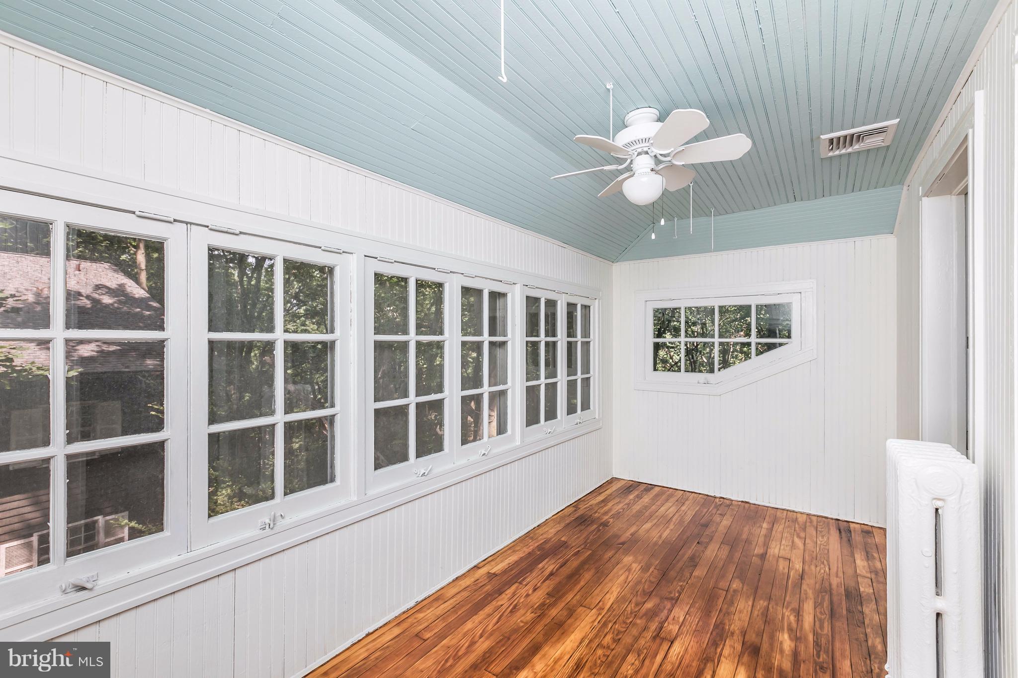 212 Longwood Road Baltimore, MD 21210 - Photo 27 of 30 a view of an empty room with a window and wooden floor