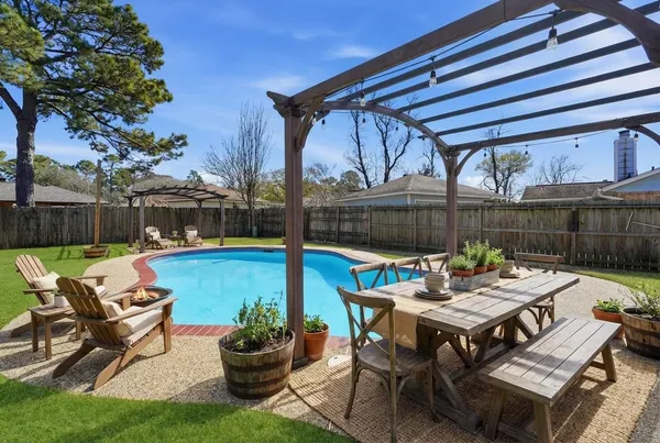 a view of a patio with a table chairs and a table
