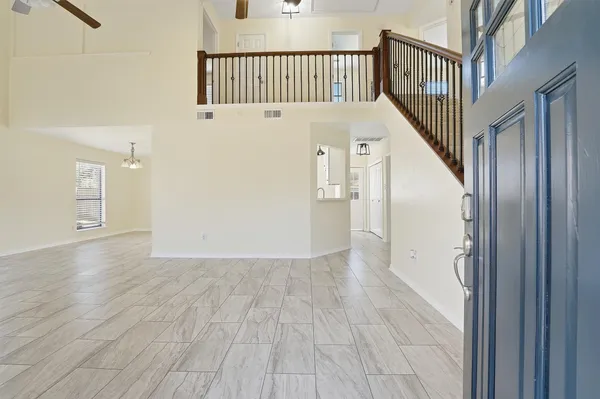 a view of a hallway with wooden floor and staircase