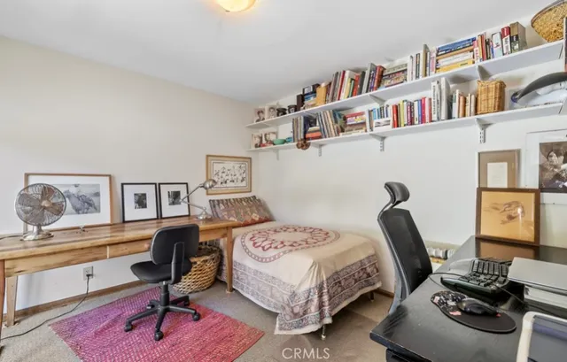 a bedroom with a bed and a bookshelf