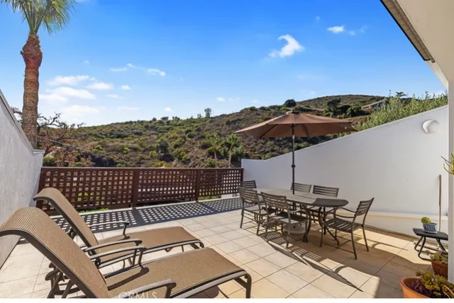 a view of a roof deck with furniture