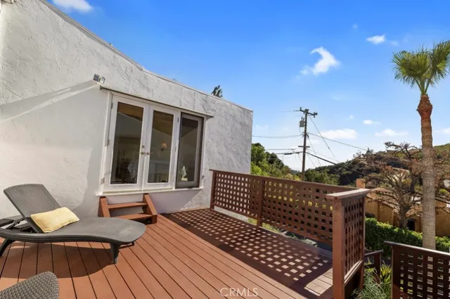 a view of a roof deck with wooden floor and fence