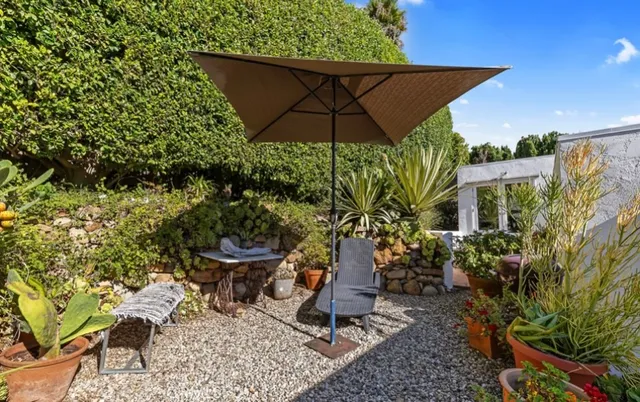 a view of a chair and table in backyard