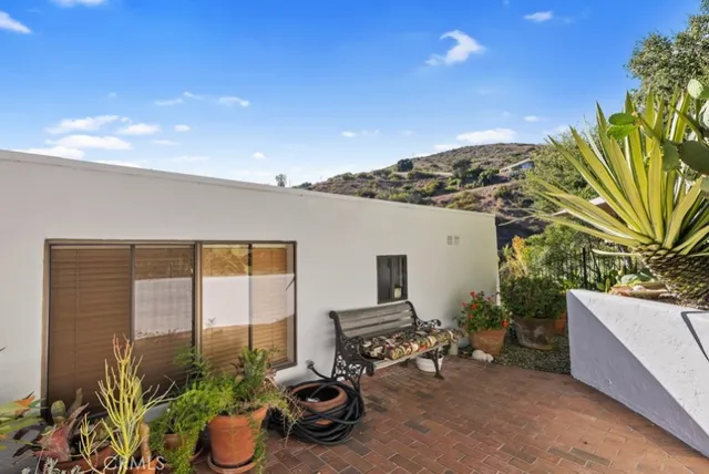 a view of a backyard with plants and patio