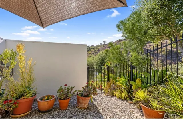 a view of a backyard with plants and table