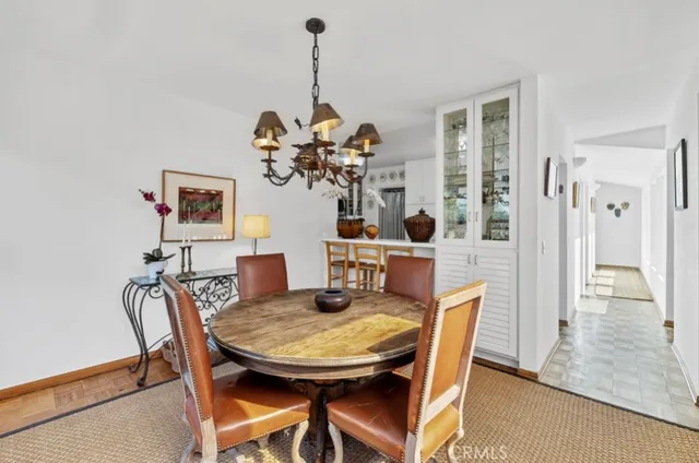 a view of a dining room with furniture and chandelier
