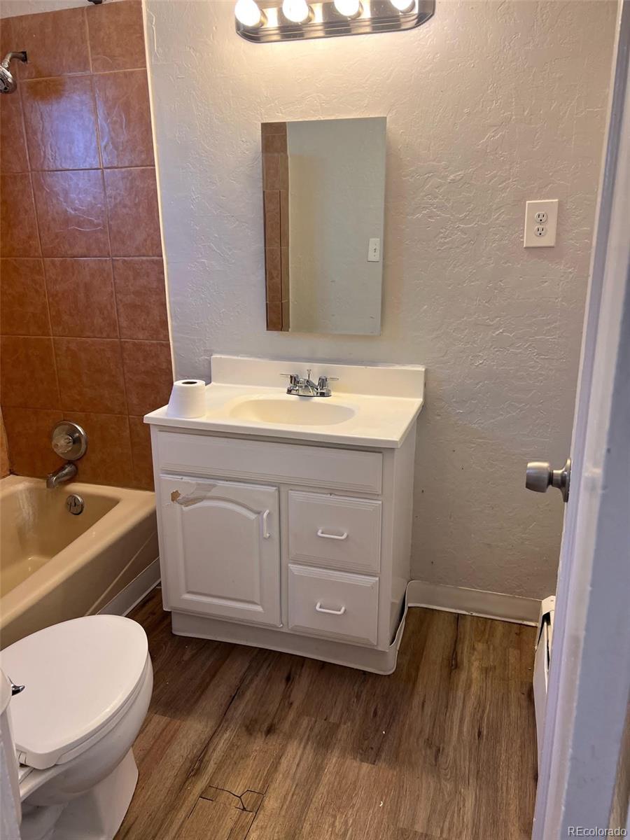3440 West Custer Place Denver, CO 80219 - Photo 19 of 22 a bathroom with a toilet sink and mirror