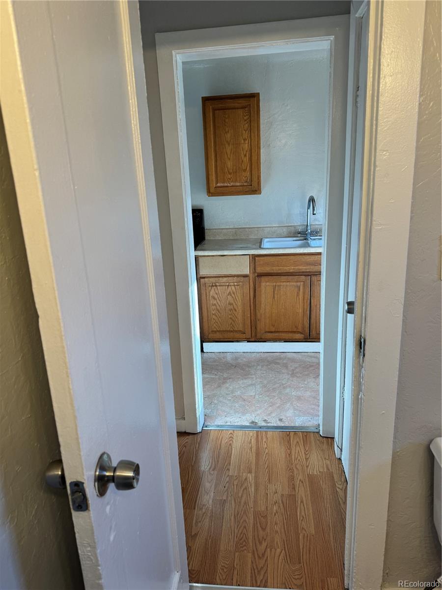 3440 West Custer Place Denver, CO 80219 - Photo 21 of 22 a bathroom with a sink and mirror
