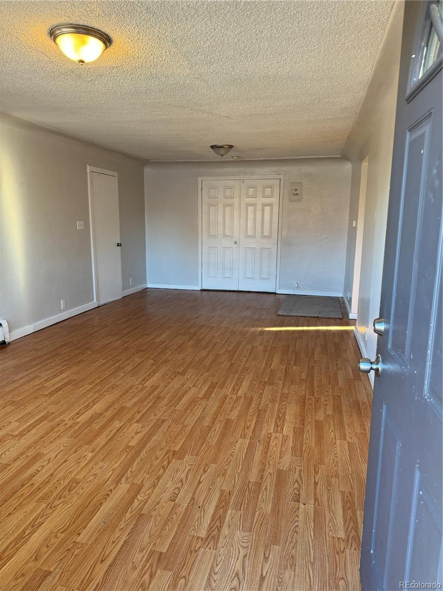 3440 West Custer Place Denver, CO 80219 - Photo 22 of 22 an empty room with wooden floor and windows