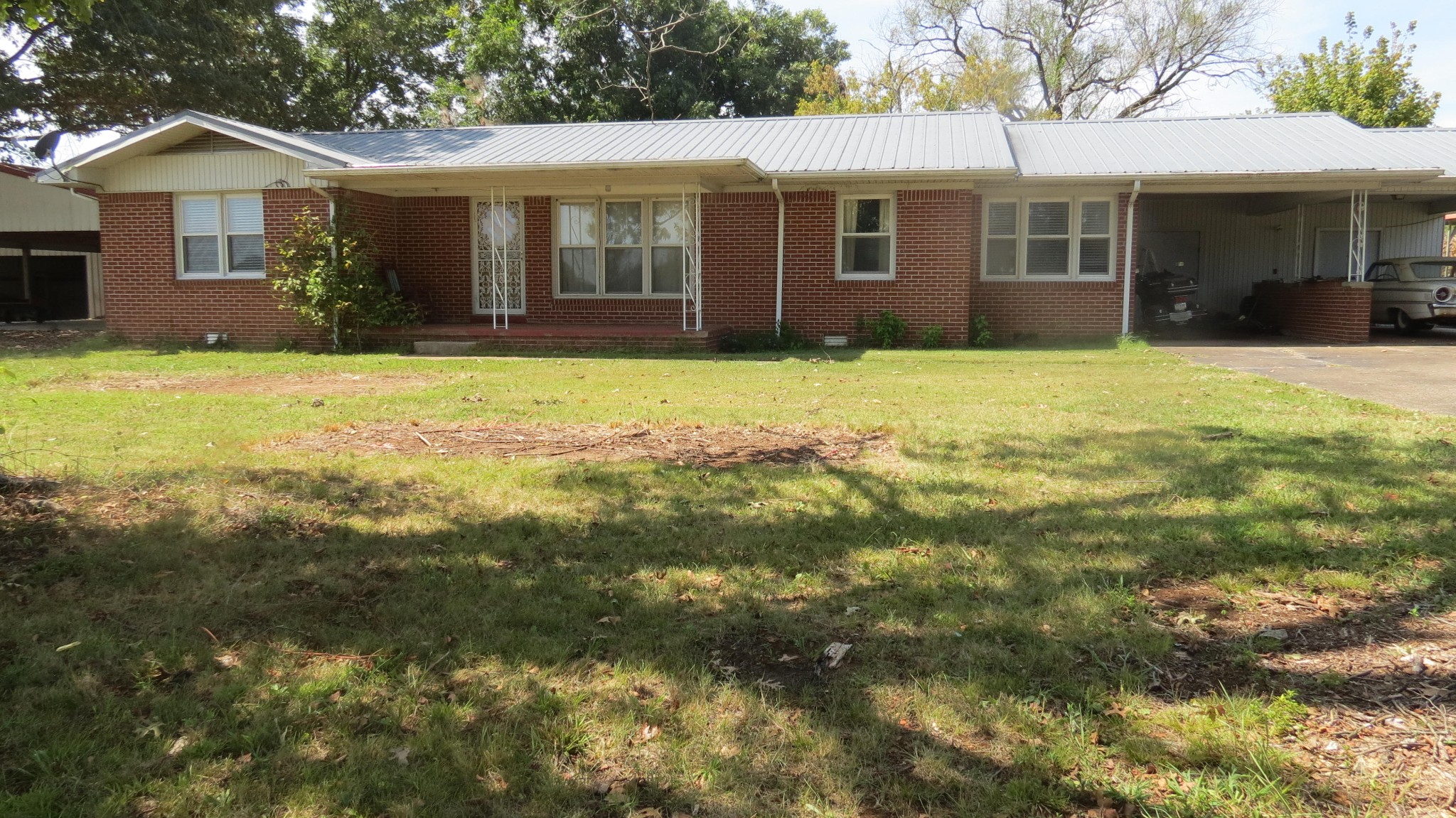 a front view of a house with a yard and potted plants