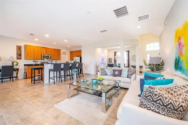 a kitchen with stainless steel appliances granite countertop a sink a stove and a wooden floors