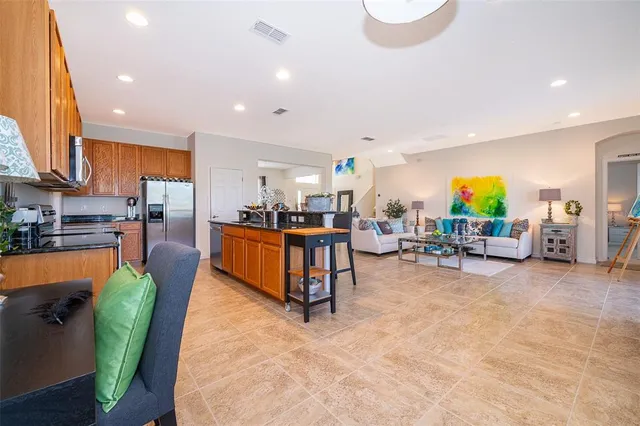 a bedroom with a bed and a refrigerator