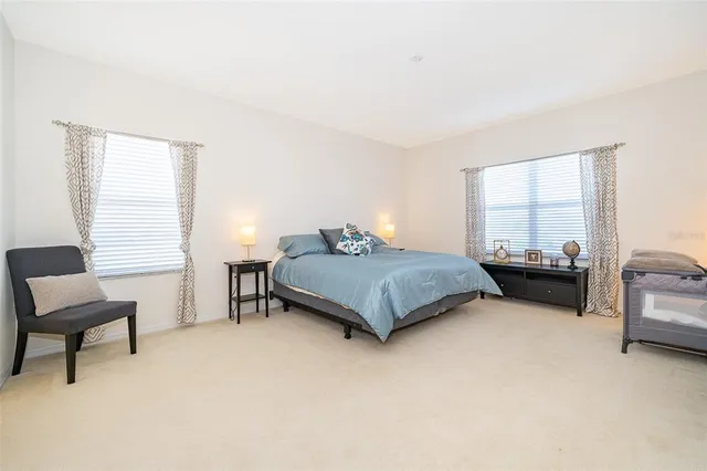 a spacious bathroom with a shower sink and mirror