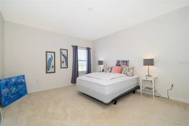 a bedroom with bed and window