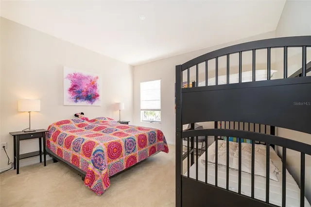 a bedroom with a bed and a lamp