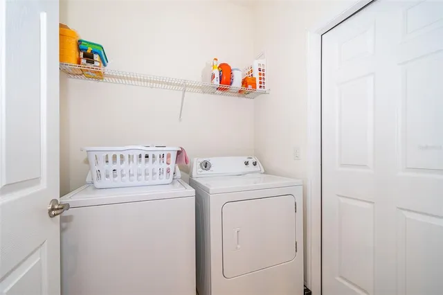 a bedroom with furniture and a large window