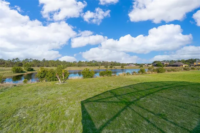 a view of a lake with houses in the background
