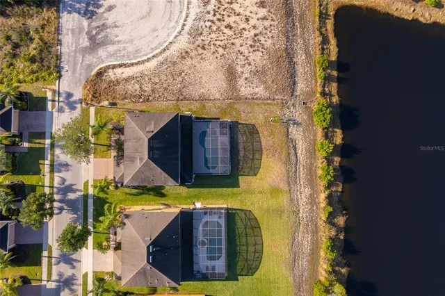 an aerial view of a house with a yard