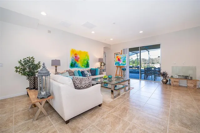 a living room with furniture and kitchen view