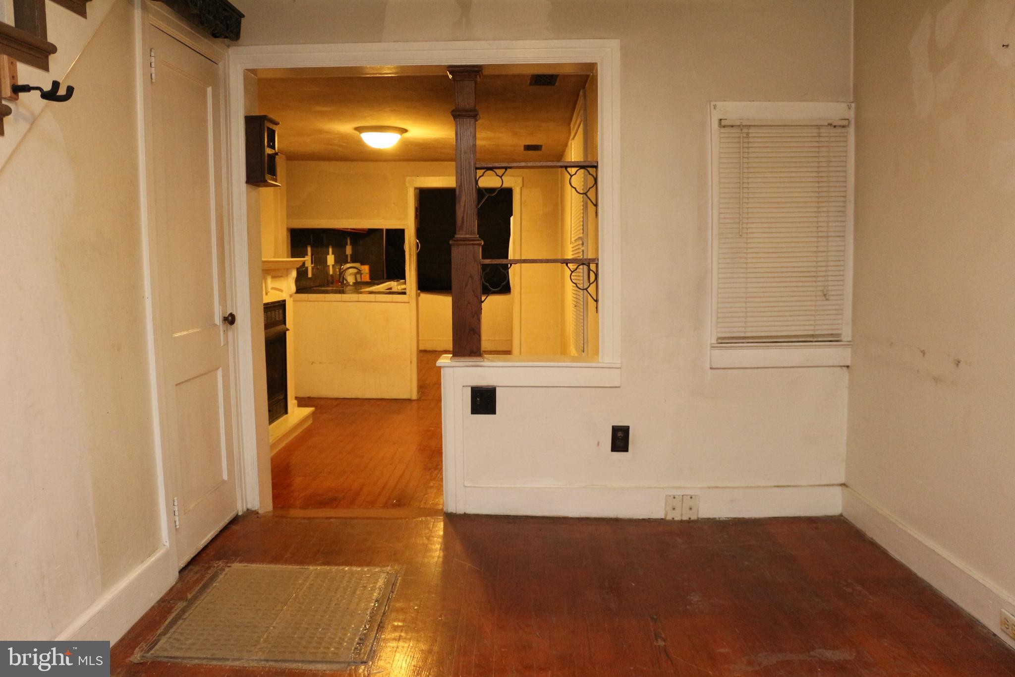 929 Washington Street Reading, PA 19601 - Photo 8 of 14 a view of a hallway with wooden floor and staircase
