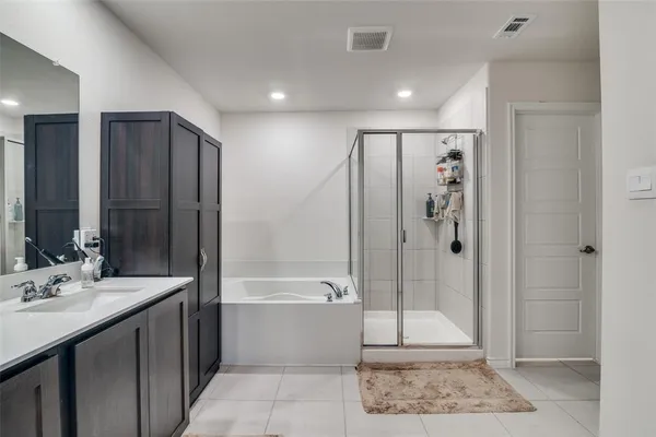 a bathroom with a double vanity sink mirror and shower