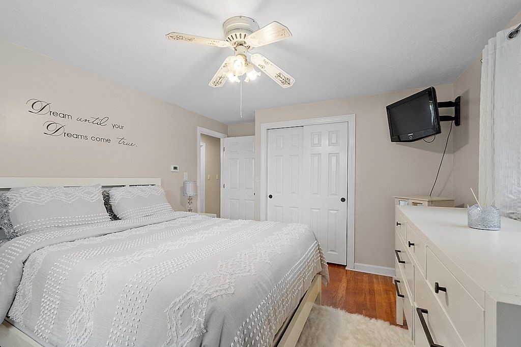 296 St Nicholas Avenue Worcester, MA 01606 - Photo 12 of 32 a bedroom with a bed and a flat tv screen on dresser