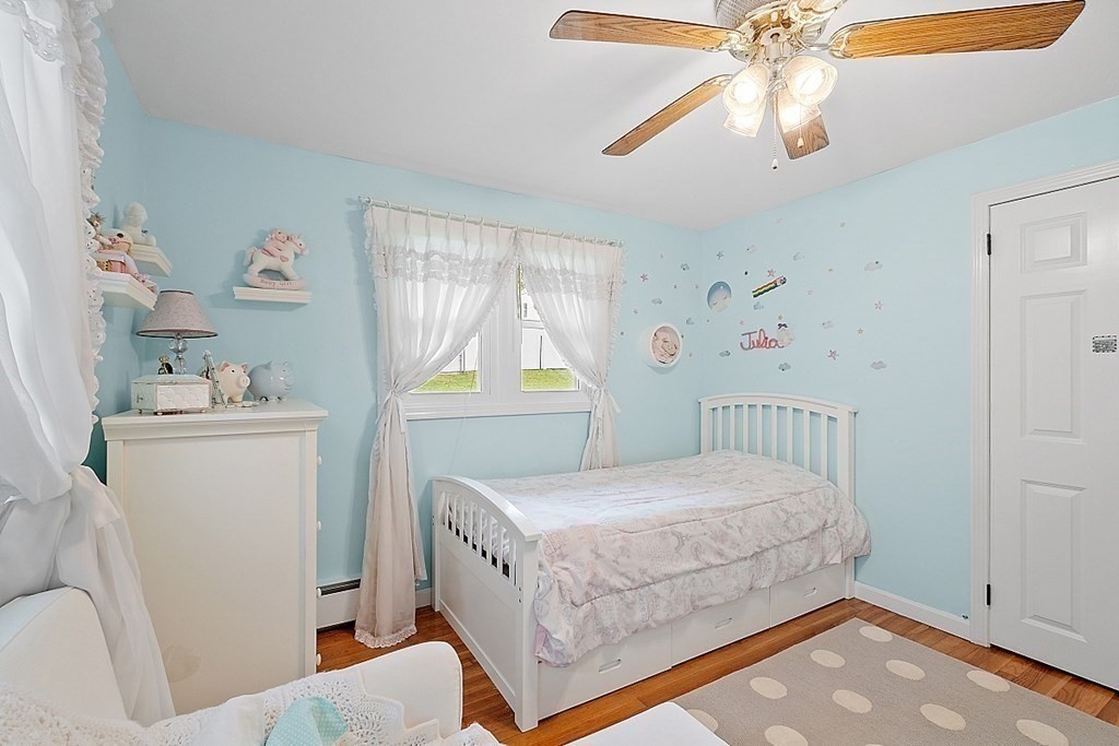 296 St Nicholas Avenue Worcester, MA 01606 - Photo 14 of 32 a bedroom with a bed and a chandelier