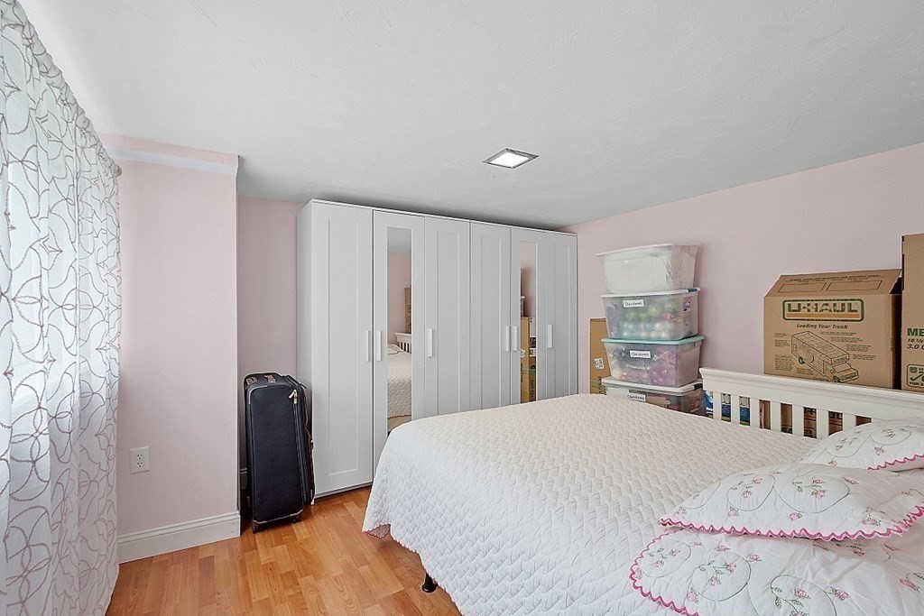 296 St Nicholas Avenue Worcester, MA 01606 - Photo 17 of 32 a bedroom with a bed and a walk in closet