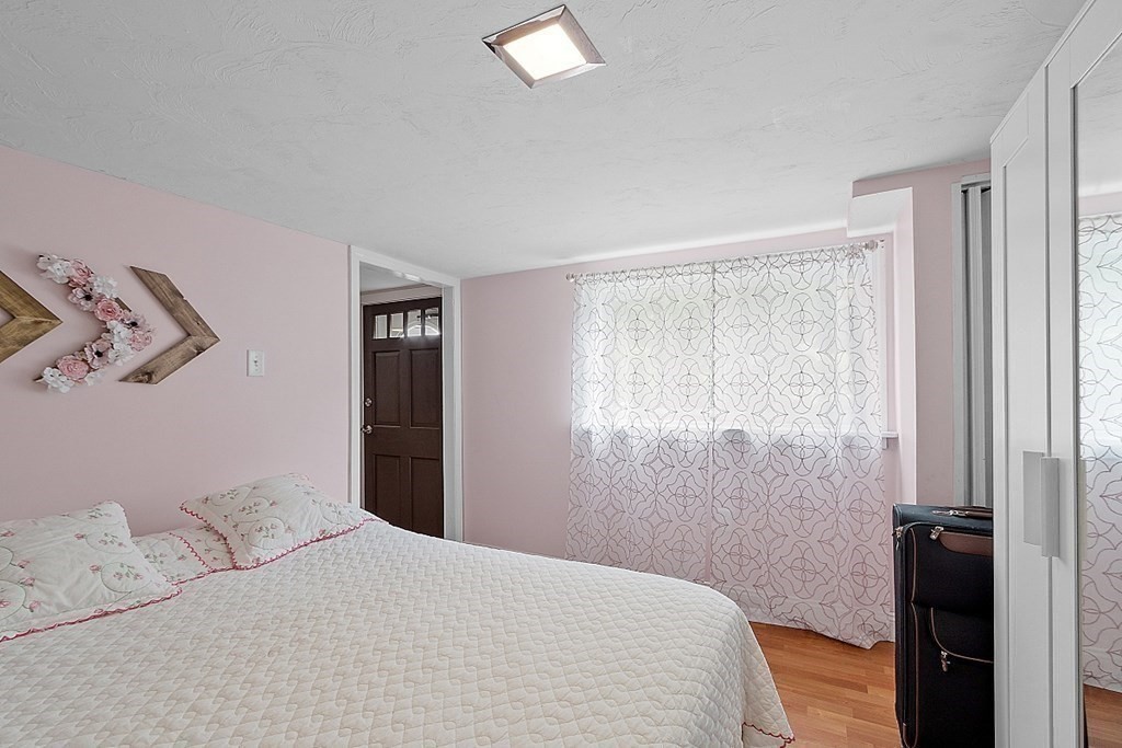 296 St Nicholas Avenue Worcester, MA 01606 - Photo 18 of 32 a bedroom with a bed and a window