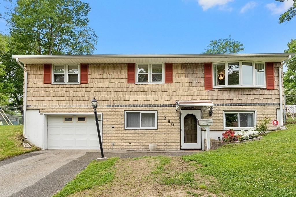 296 St Nicholas Avenue Worcester, MA 01606 - Photo 26 of 32 a front view of a house with a yard and garage