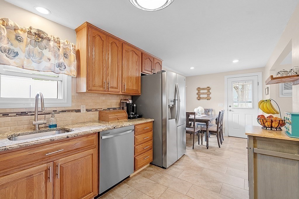 296 St Nicholas Avenue Worcester, MA 01606 - Photo 3 of 32 a kitchen with stainless steel appliances granite countertop a refrigerator and a stove top oven