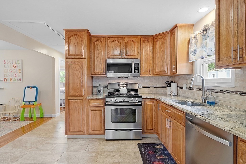 296 St Nicholas Avenue Worcester, MA 01606 - Photo 4 of 32 a kitchen with stainless steel appliances granite countertop a stove top oven a sink dishwasher and cabinets