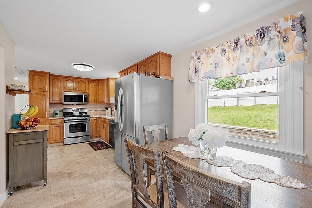 296 St Nicholas Avenue Worcester, MA 01606 - Photo 5 of 32 a kitchen with stainless steel appliances granite countertop a refrigerator a stove a sink and a dining table with wooden floor