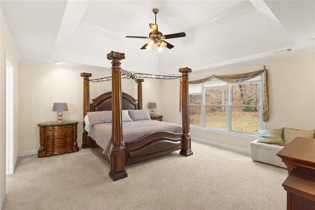 67 Pointer Lane Braselton, GA 30517 - Photo 19 of 45 a bedroom with a bed and a chandelier