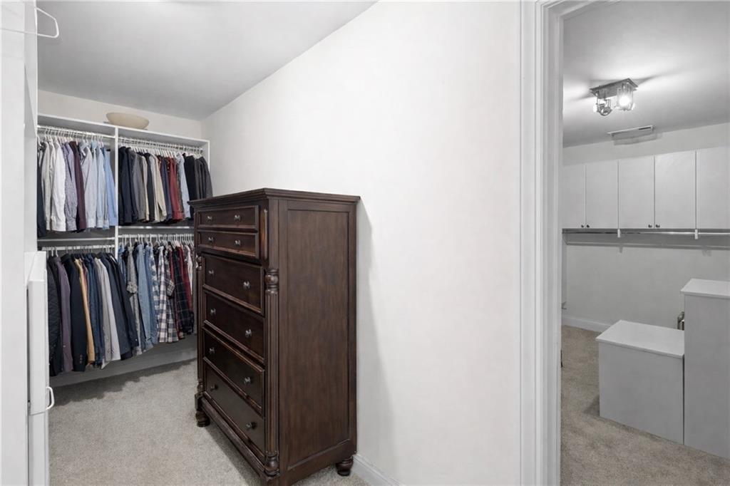 67 Pointer Lane Braselton, GA 30517 - Photo 21 of 45 a view of walk in closet with clothes and shoes