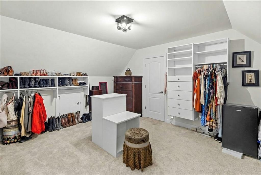 67 Pointer Lane Braselton, GA 30517 - Photo 23 of 45 a living room with furniture a ceiling fan and a book shelf