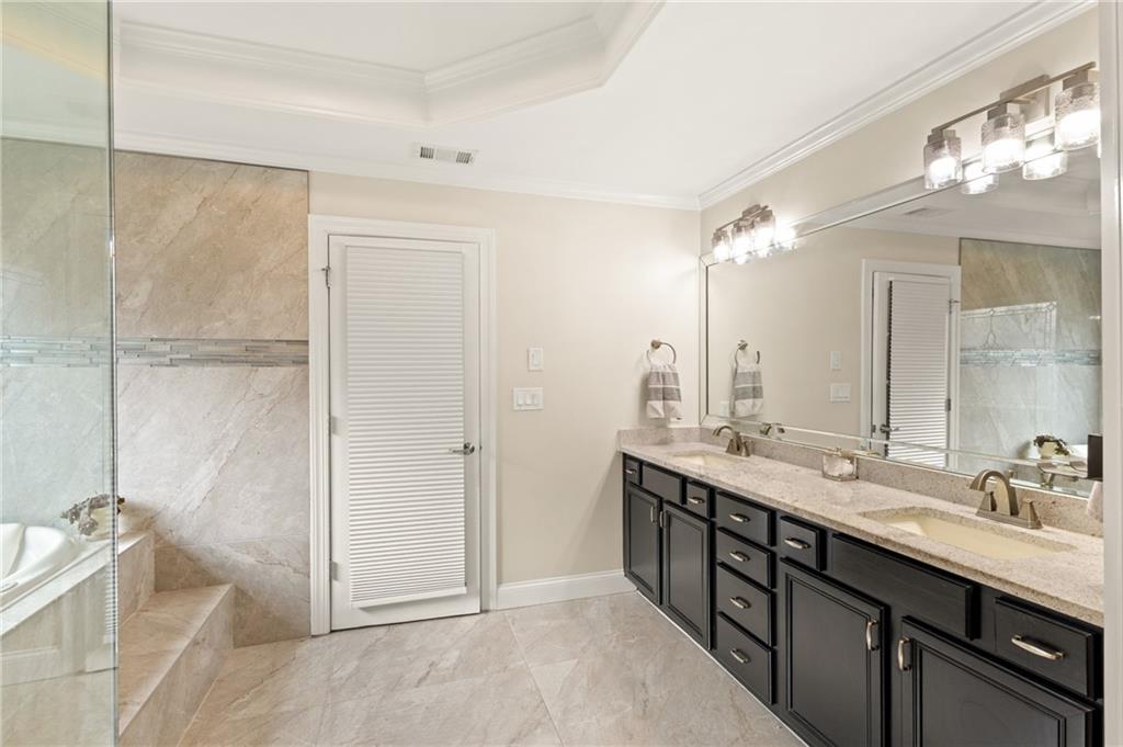 67 Pointer Lane Braselton, GA 30517 - Photo 25 of 45 a spacious bathroom with a double vanity sink a large mirror and a shower
