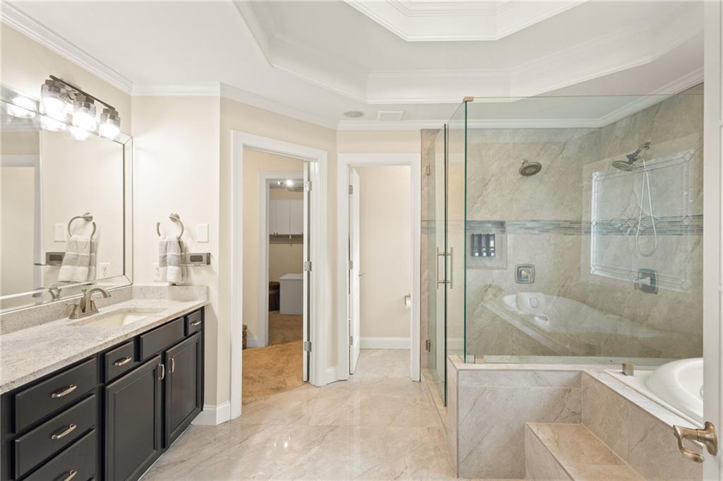 67 Pointer Lane Braselton, GA 30517 - Photo 26 of 45 a spacious bathroom with a shower sink and mirror