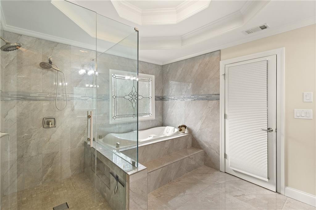 67 Pointer Lane Braselton, GA 30517 - Photo 29 of 45 a bathroom with a glass shower door