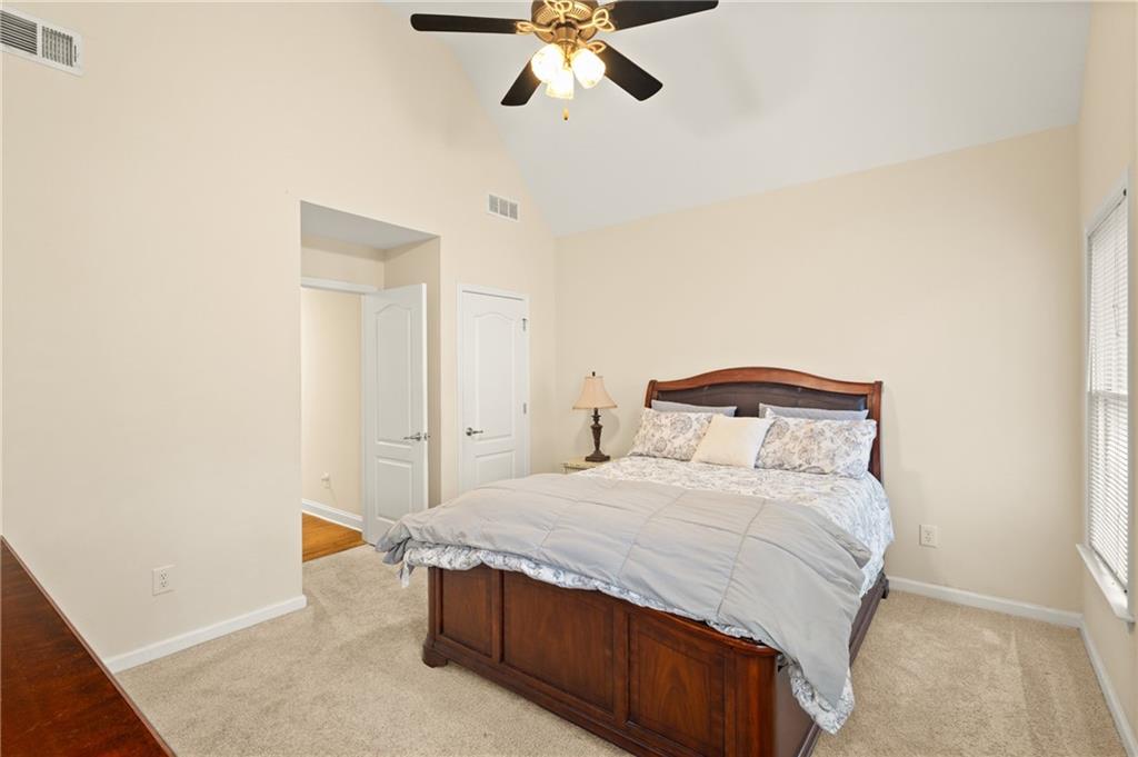 67 Pointer Lane Braselton, GA 30517 - Photo 32 of 45 a bedroom with a bed and a chandelier